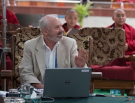 scott gilbert at a computer teaching a lesson to monks and the dalai lama